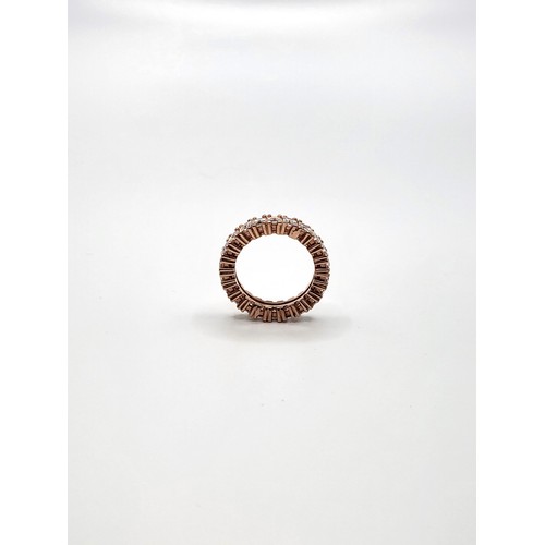 392 - A rose gold-plated silver stamped S 925, princess cut cubic zirconia full eternity ring. 4.8gms Size... 