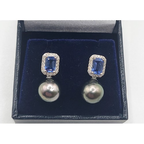 394 - A pair of black pearl, step cut sapphire and diamond drop earrings, boxed. Sapphires 1.41ct approx. ... 