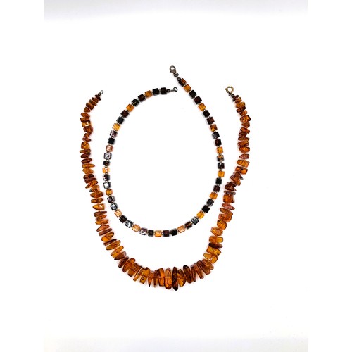 395 - An amber irregular shaped ascending sized necklace with a gold jump ring clasp, 47cm 34.1gms, and an... 