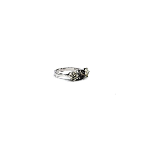 398 - A marked 18ct white gold three stone diamond ring the central cognac coloured.  2.08cts total. 4.3gm... 