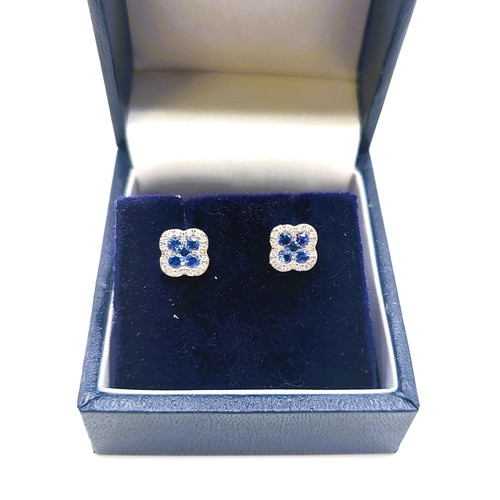 399 - A pair of 18ct white gold sapphire and diamond clover leaf stud earrings. 1.8gms