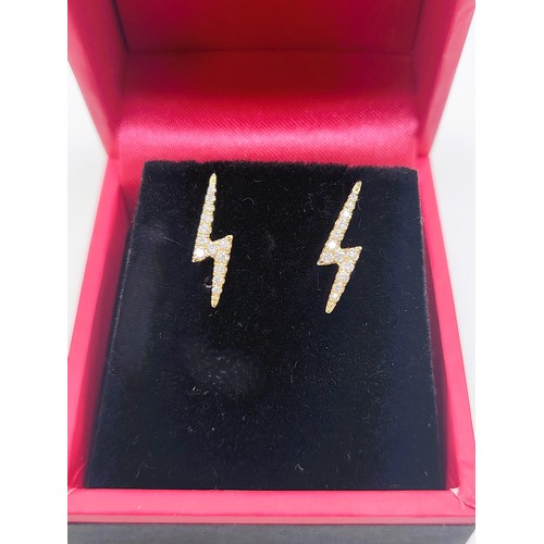 402 - A pair of 9ct yellow gold lightning bolt diamond stud earrings. 1.2gms