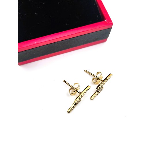 402 - A pair of 9ct yellow gold lightning bolt diamond stud earrings. 1.2gms