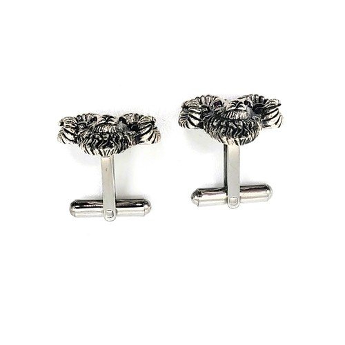 406 - A pair of silver (stamped sterling) rams headed cufflinks 13.1gms 2.5cm x 2cm.