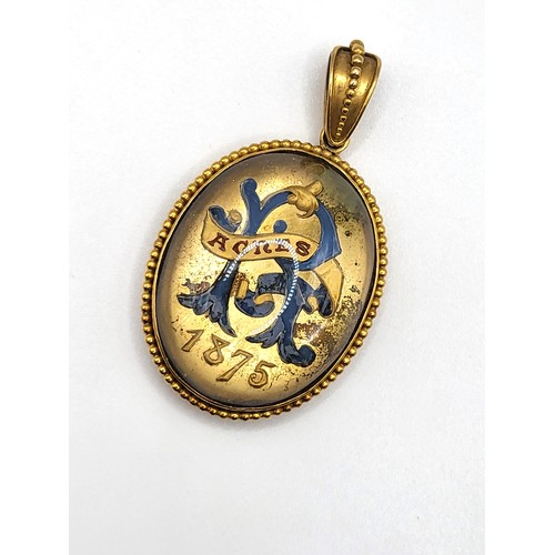 412 - A Victorian glass top pendant/ memento mori locket in gilt metal, and three brooches including a ova... 