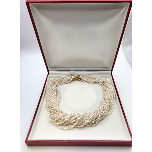 417 - A multi-strand freshwater pearl choker necklace with an 18ct gold clasp (483 VI 750) 47cm 205gms. Bo... 