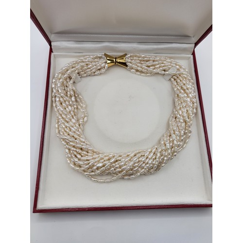 417 - A multi-strand freshwater pearl choker necklace with an 18ct gold clasp (483 VI 750) 47cm 205gms. Bo... 