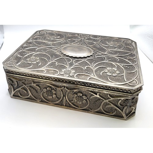 418 - An arts and craft jewellery box with floral design, a burgundy baize interior with mixed sized compa... 