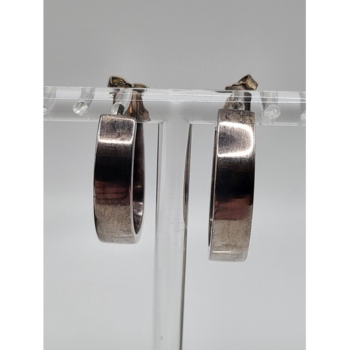 428 - A Georg Jensen pair of silver D-shaped hooped earrings, boxed. 109gms. 2.5cm drop (0.7cm width)