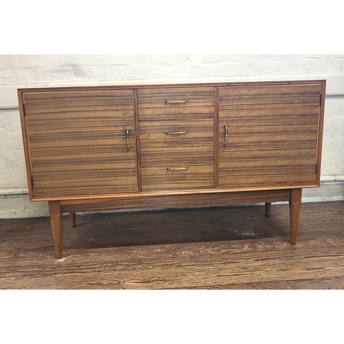 1 - A mid-century 'Alfred Cox' sideboard with three drawers (top one being for cutlery), and flanked by ... 