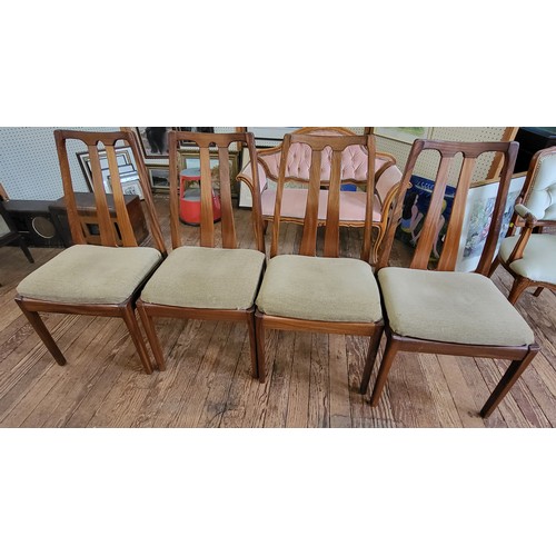 7 - Four Nathan dining chairs with padded seats.