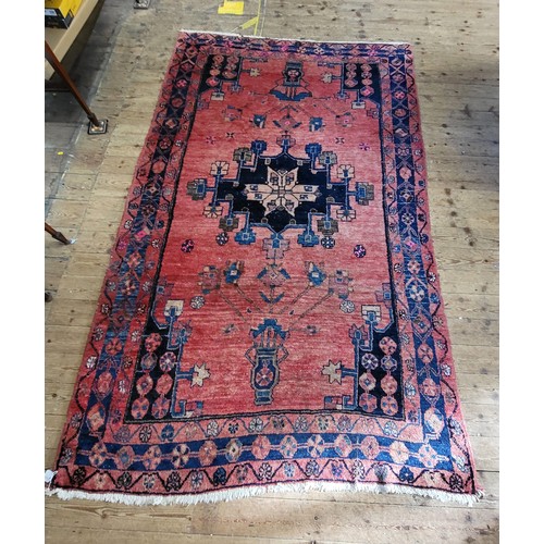 48 - A blue and red rug. 150cm x 250cm.