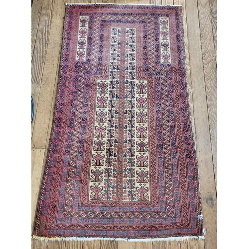 49 - A predominantly red ground rug. 85cm  x 155cm.