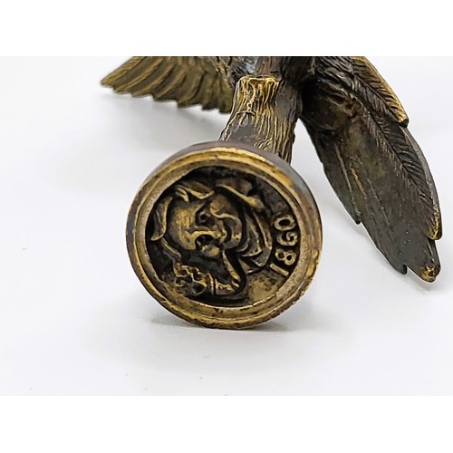 120 - A brass cased pipe tamper and document seal in the form of a parrot on a branch. The seal is of a ma... 