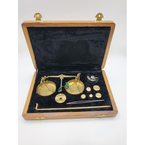 152 - Complete set of brass balance scales (up to 20gms) in wooden case.