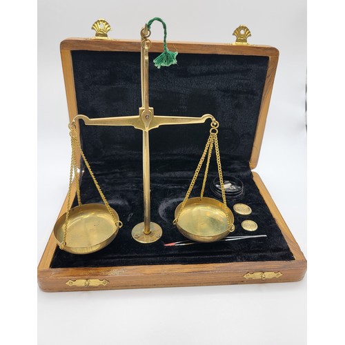 152 - Complete set of brass balance scales (up to 20gms) in wooden case.