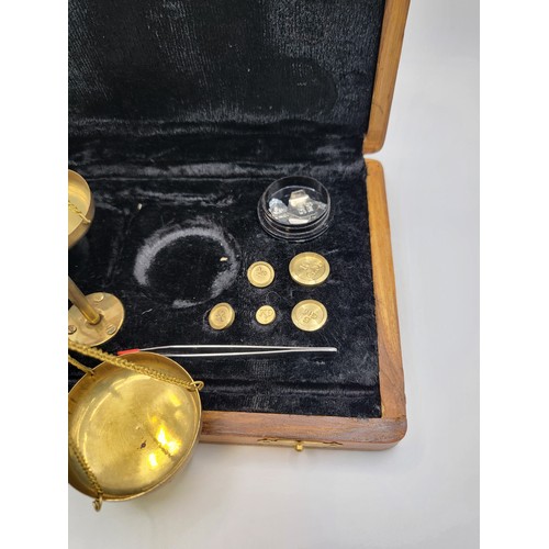 152 - Complete set of brass balance scales (up to 20gms) in wooden case.