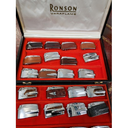 165 - A collection of twenty-four Ronson Varaflame lighters in an original leather bound display case. All... 