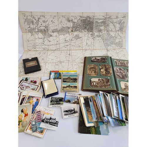 211 - Book of postcards and a concertina cartograph map and a Bible and more postcards