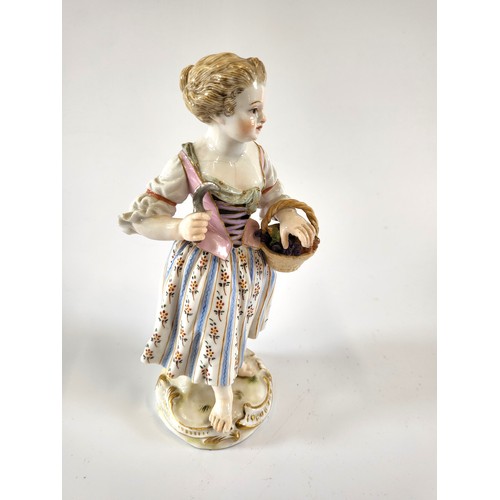 216 - A late Meissen porcelain figure of a girl with basket of bunches of grapes and sickle. 14cm