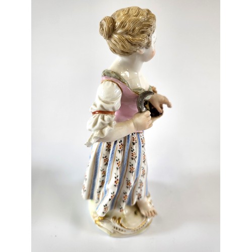 216 - A late Meissen porcelain figure of a girl with basket of bunches of grapes and sickle. 14cm