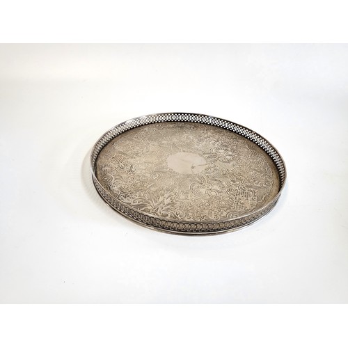 262 - A round 'Arthur Price' silver coloured tray with heavy foliate engraving and lattice edge 28cm diame... 