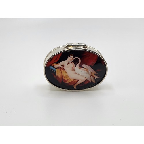 274 - An oval silver pill box with enamel lid depicting Leda and the swan. 3.5cm x 2.5cm. 18.4gms.