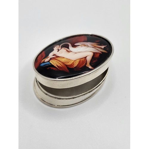 274 - An oval silver pill box with enamel lid depicting Leda and the swan. 3.5cm x 2.5cm. 18.4gms.