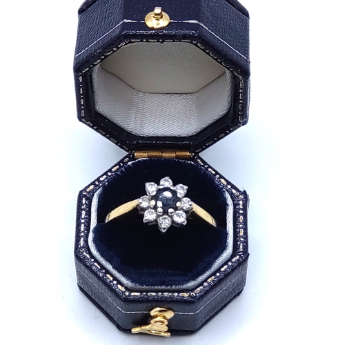 292 - A yellow metal, sapphire, and diamond floral cluster ring, set with a dark blue round-cut sapphire w... 