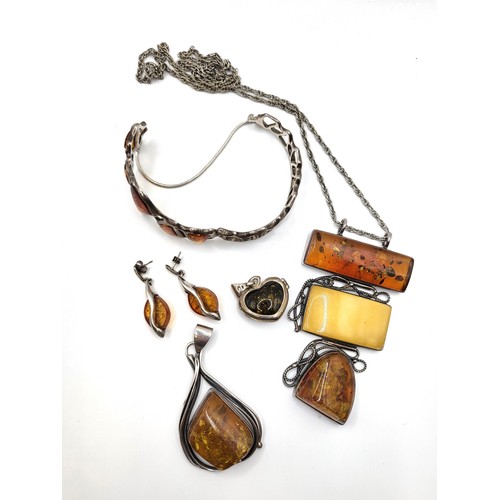 294 - A bag of jewellery including silver and amber bracelet with safety chain, a silver, amber  and honey... 