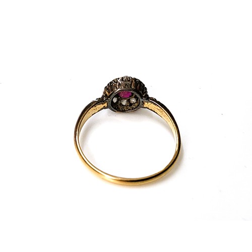 303 - A rose gold diamond spinel ruby centre ring