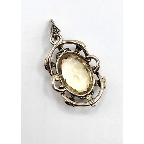 313 - An oval citrine pendant in white and yellow metal (stamped 935 on the bale) 3.5cm x 2cm, and a match... 