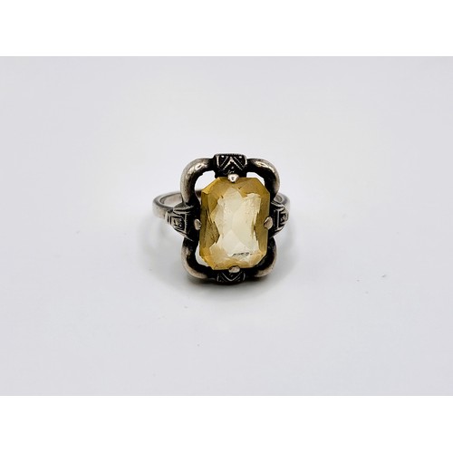 313 - An oval citrine pendant in white and yellow metal (stamped 935 on the bale) 3.5cm x 2cm, and a match... 