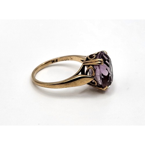 320 - A 9ct yellow gold oval amethyst set ring. 2.9gms. Size L 1/2.