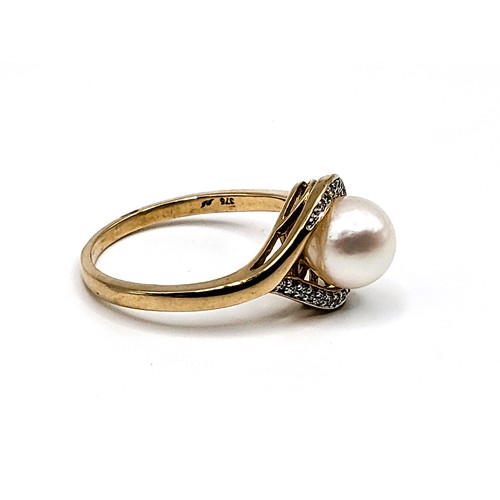 327 - 9ct yellow gold white cultured pearl and diamond half moon ring. Diamond 0.05ct. 2.8gms. Size N.