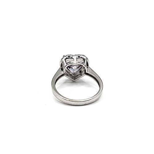 331 - A silver ring set with a large heart shaped white cubic zirconia at the centre, with smaller white c... 