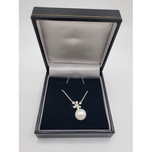 333 - A 9ct white gold snowflake-style 9mm cultured pearl and diamond necklace, boxed. Round brilliant cut... 