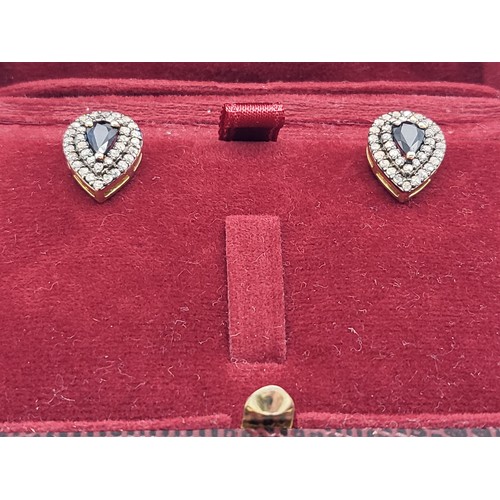 337 - A pair of silver-gilt drop shaped stud earrings set with pear shaped sapphires and diamond double ha... 