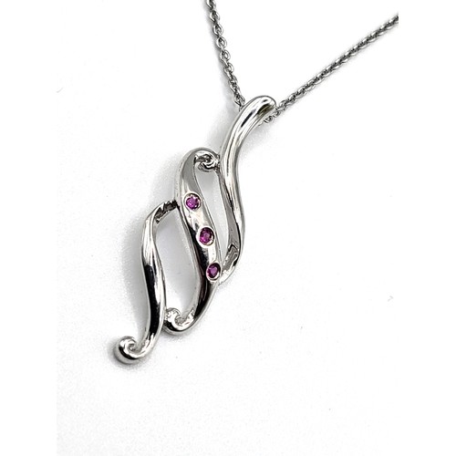 340 - A silver 'flame' pendant set with three tourmaline on a silver chain 46cm.  2.9gms.