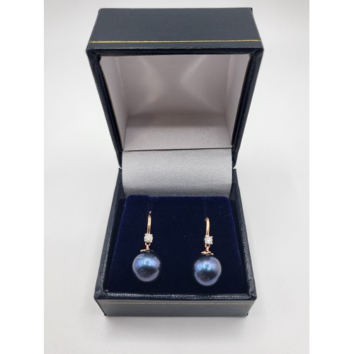 351 - A pair of 9ct rose gold iridescent 9mm dark pearl and round brilliant cut diamond drop earrings, box... 