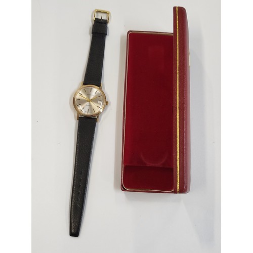 376 - A Garrard vintage gold plated quartz date/just on a leather strap.