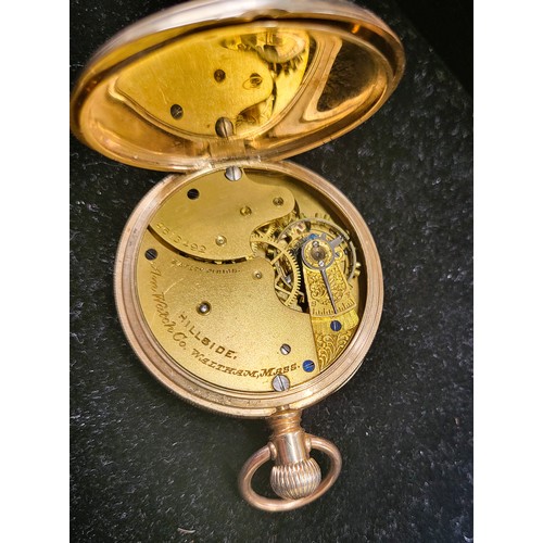 374 - A Waltham 10ct gold pocket watch. 4.5 cm diameter. Running and on a metal fob chain. 102gms.