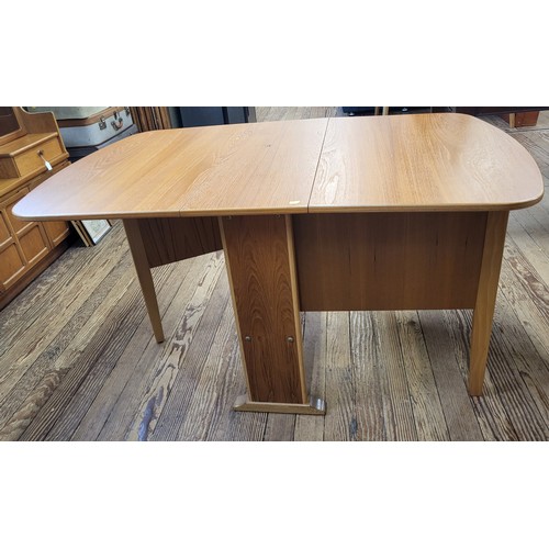 18 - A teak gate leg table