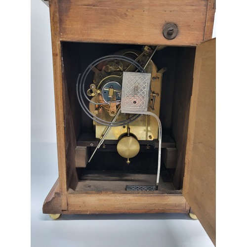 34 - A large oak mantle clock with decorative brass surround. Possibly German. 42cm x 28cm x 22cm.