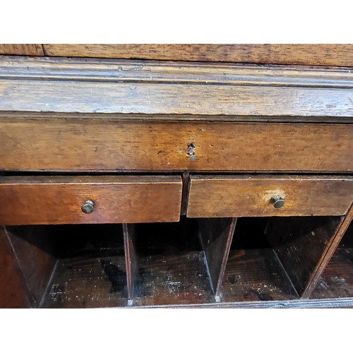 5 - An oak bookcase on bureau. Two doors cupboard with three shelves over a fold down writing desk with ... 