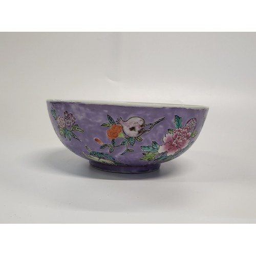 188 - A Chinese Peranaken Straits porcelain bowl with floral decoration on a purple ground, signature init... 