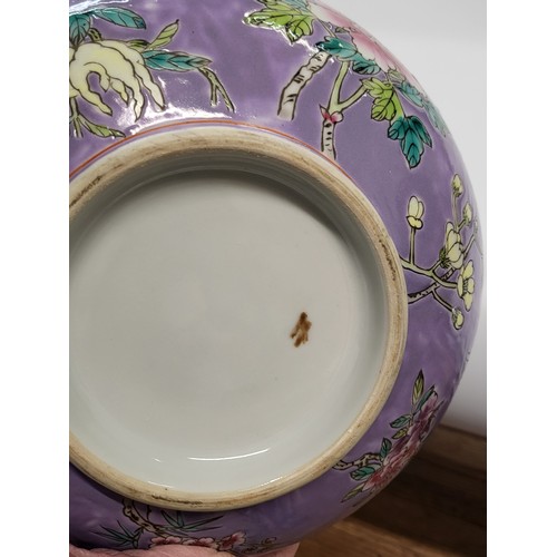 188 - A Chinese Peranaken Straits porcelain bowl with floral decoration on a purple ground, signature init... 