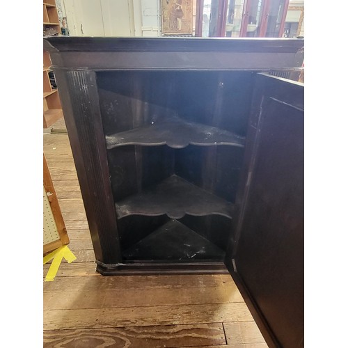 24 - An antique mahogany corner cabinet with two shelves and a door with key. Brass knob.114cm x 90cm x 5... 