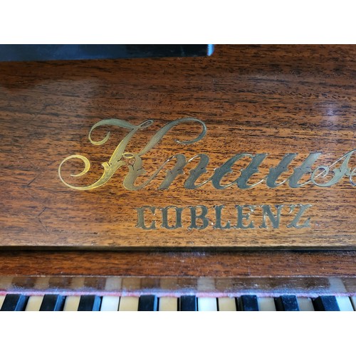 26 - A Krauss Coblenz upright piano supplied by Harrods of London. Circa 1886. 124cm x 140cm x 62cm.