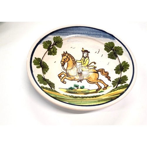 193 - A 23.5cm diameter pottery bowl with hand painted horse with rider decoration (Delfe style) with init... 